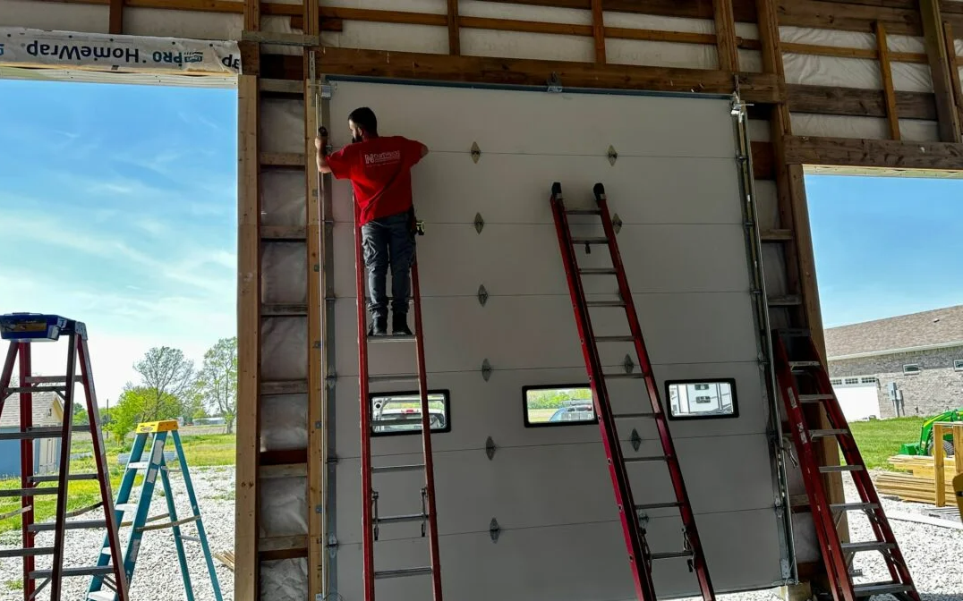 a skilled technician performing a garage door installation in Cloud, FL, highlighting professional and reliable garage door services.