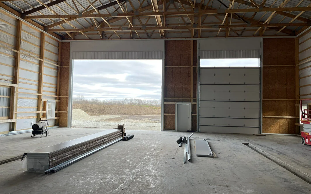 a technician performing garage door panel repair in Cloud, FL, highlighting expert and efficient panel restoration services.