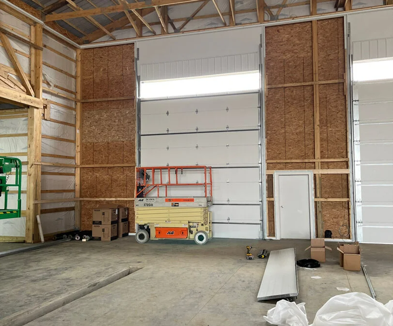 a technician replacing a damaged garage door section in Cloud, FL, emphasizing expert garage door section replacement services.