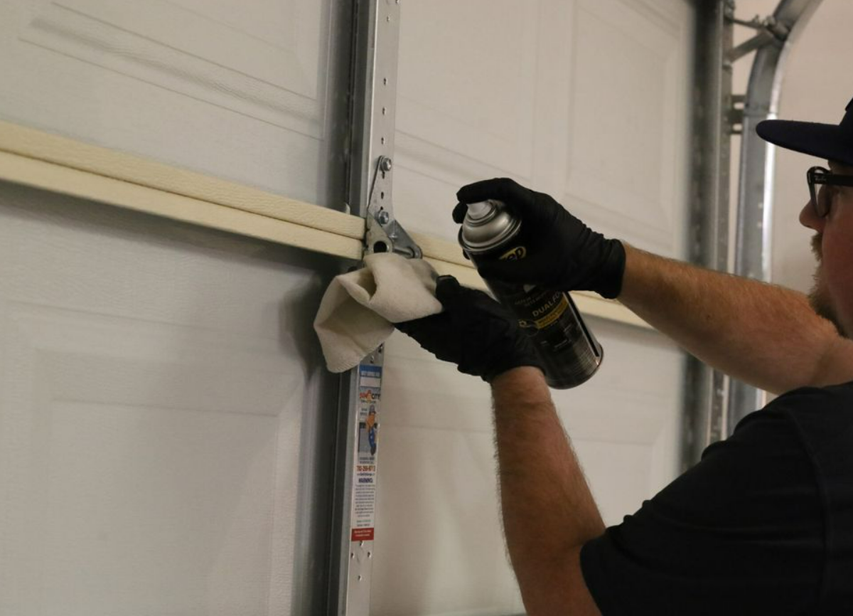 a technician performing garage door track repair in Cloud, FL, showcasing professional and efficient track repair services.