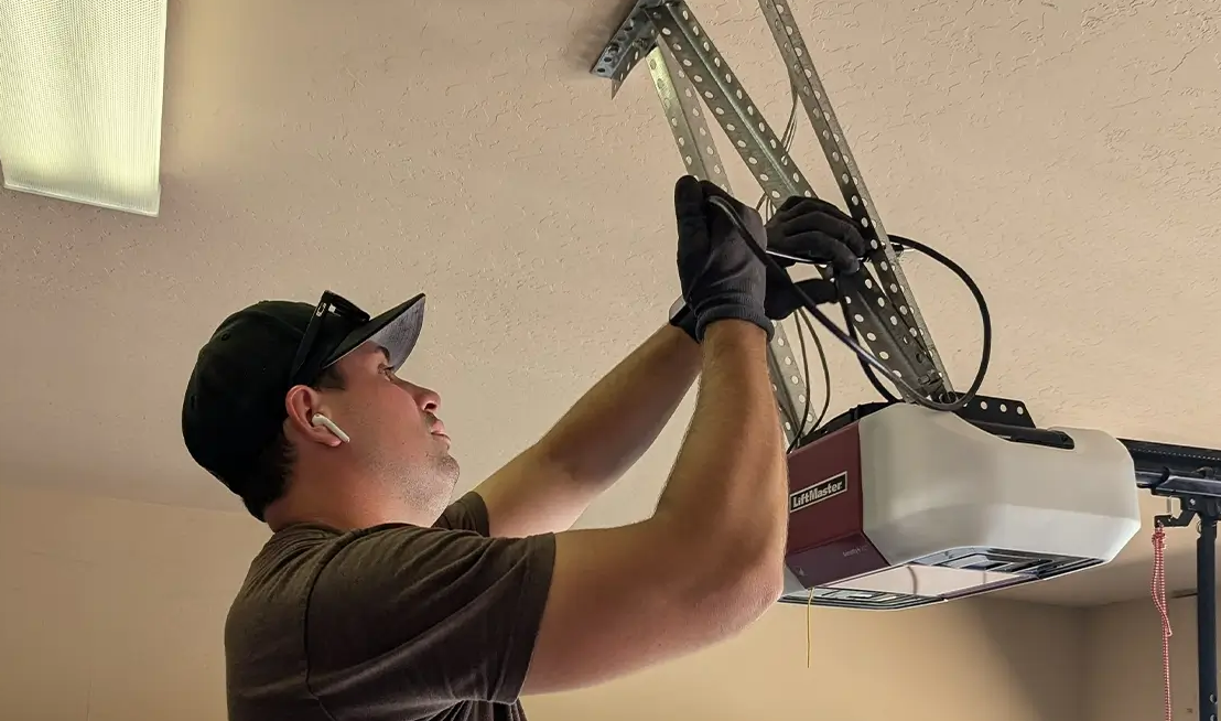 a technician performing a garage door opener installation in Cloud, FL, highlighting expert and reliable opener installation services.