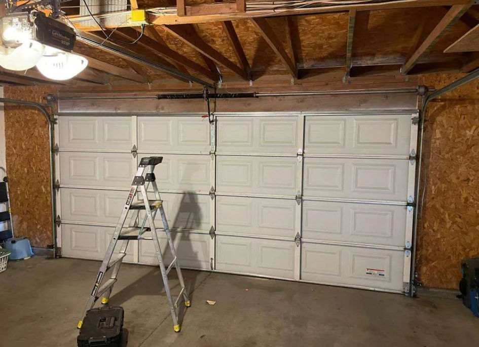 Professional technician performing garage door repair service on a residential garage door in Florida - enhance security and functionality with expert repairs.