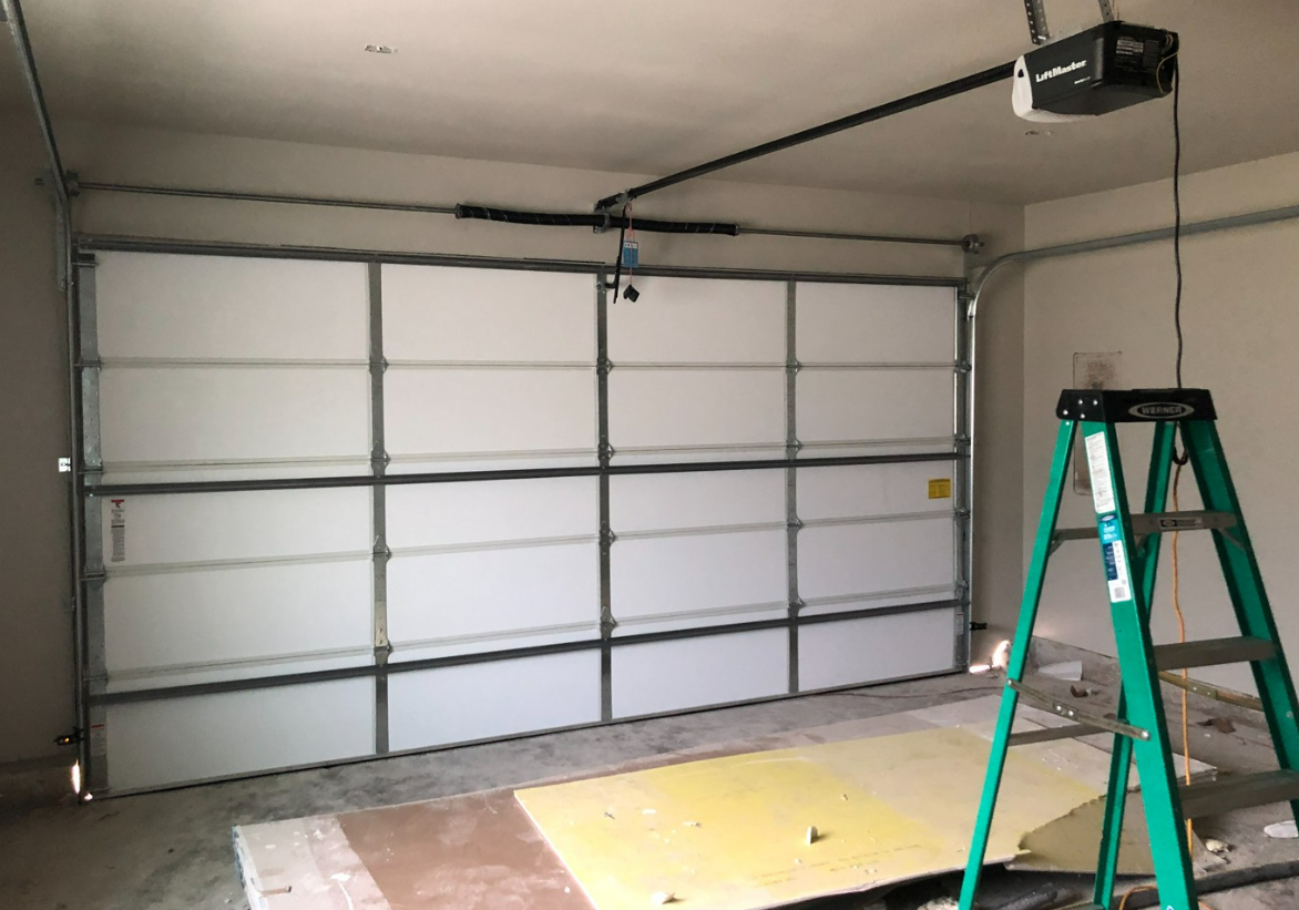 Professional technician repairing a residential garage door with precision tools in a Florida home, showcasing expert garage door repair services for secure and reliable access.