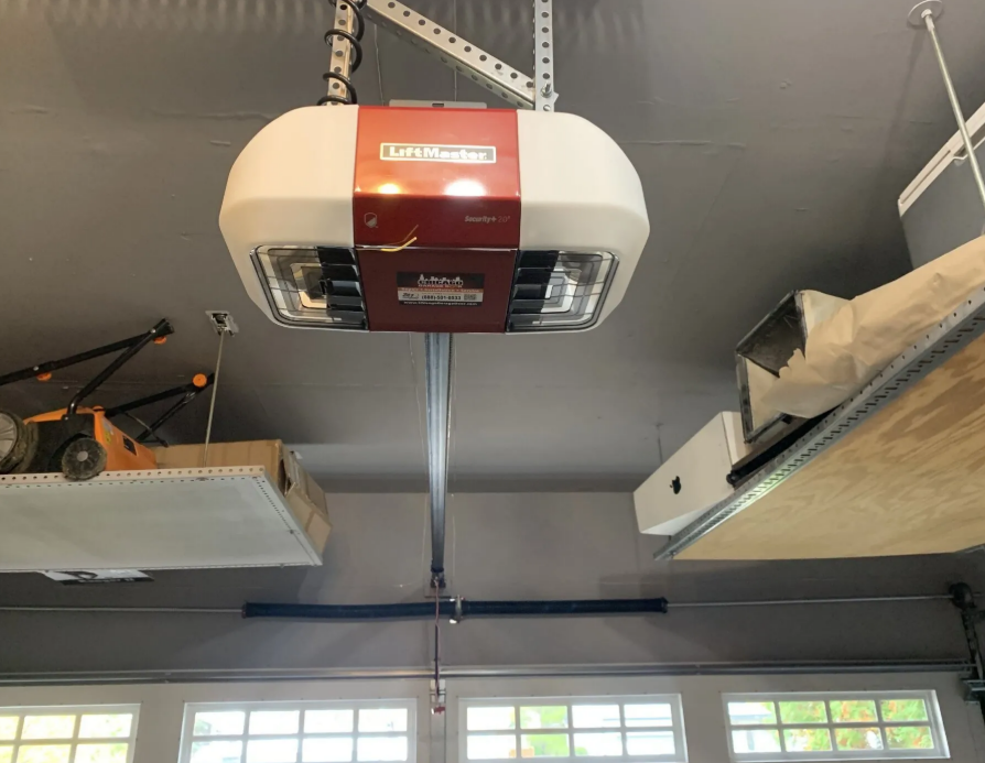 An experienced technician repairing a residential garage door opener, showcasing the intricate mechanism and tools used in the process, highlighting the quality and expertise of Garage Door Repair Services Cloud FL.