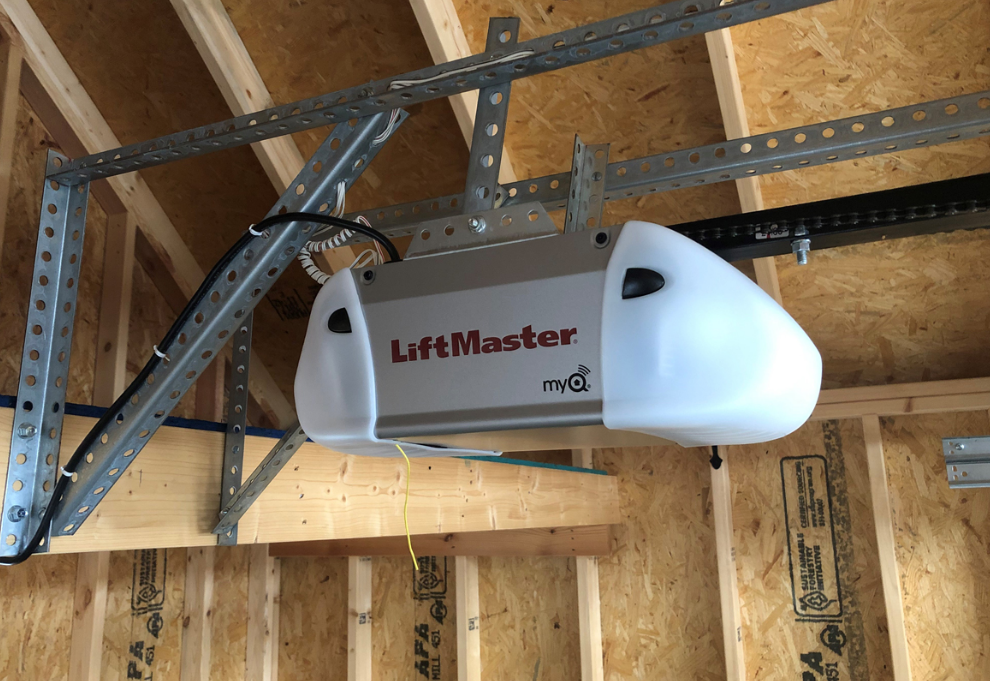 technician repairing a garage door opener in Florida with tools and equipment visible, representing expert garage door repair services